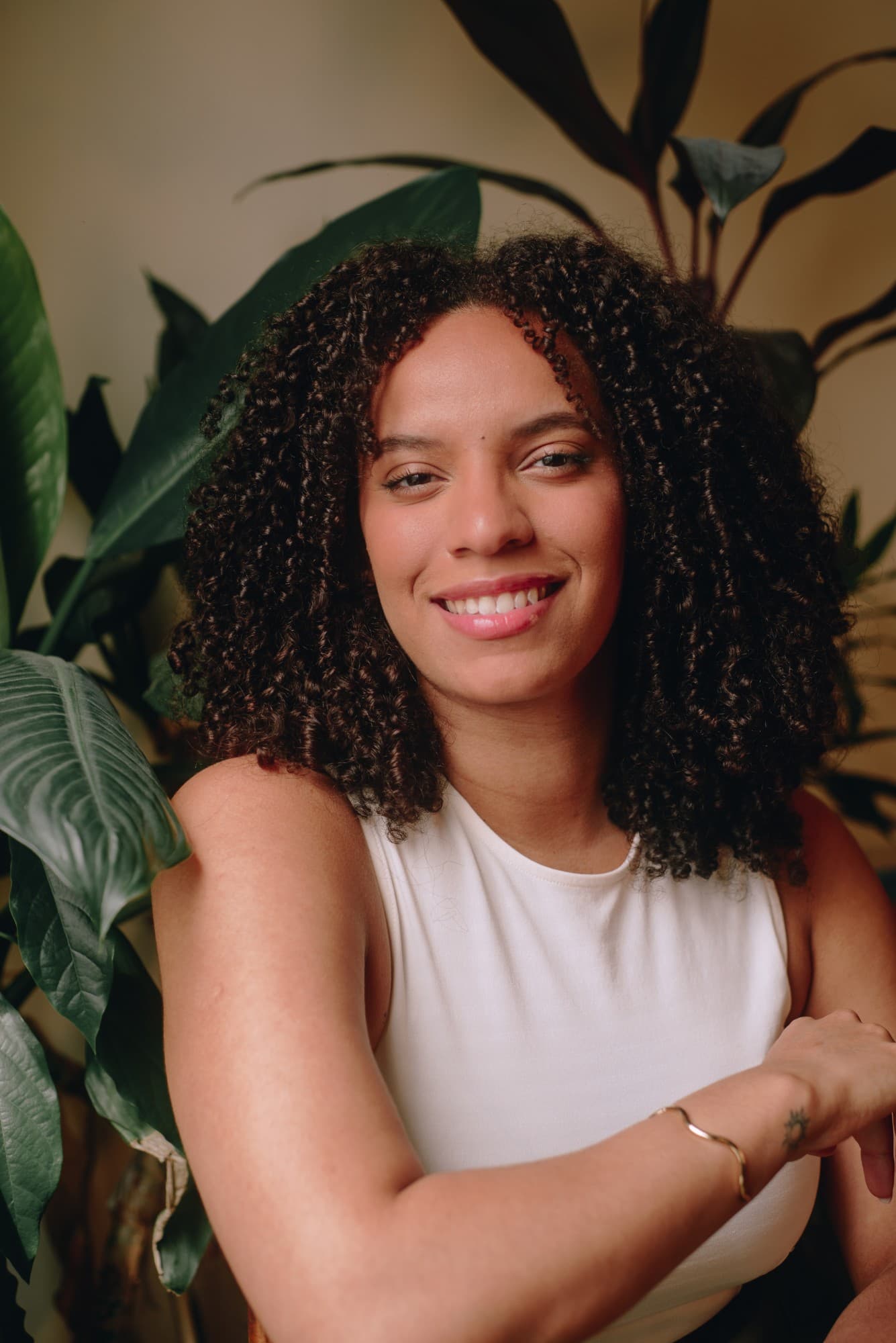 Rebeca smiling in front of tropical plants